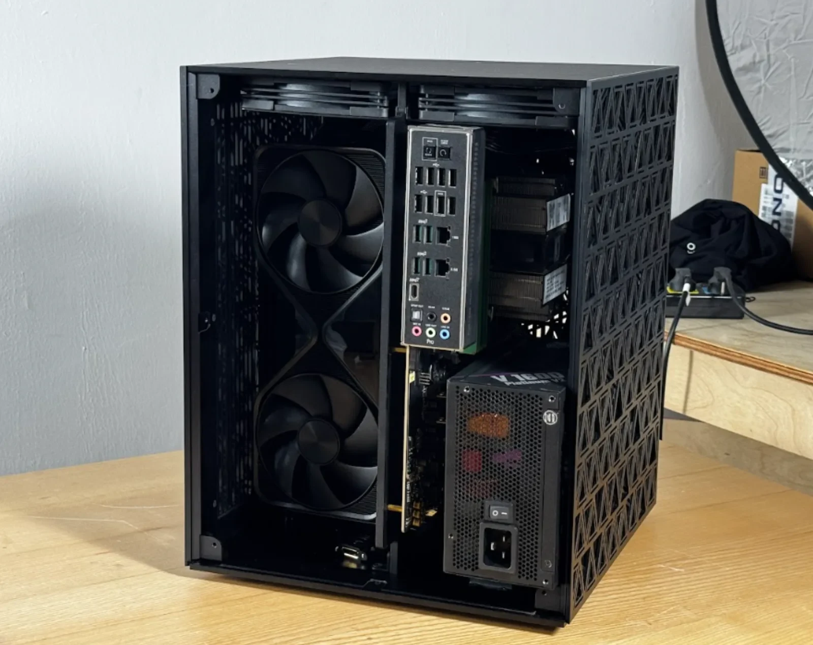 Enclosed tower concept for a four-GPU RTX 5090 local AI system, showing two large vertical intake fans, rear I/O, power supply, drive bays, and ventilated side panels.