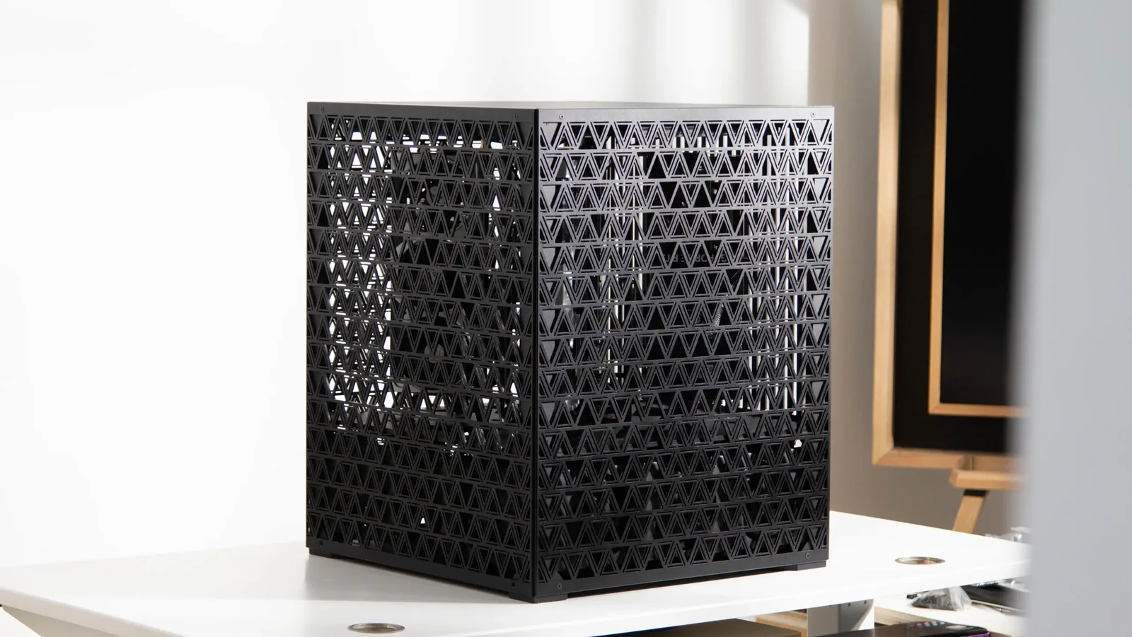Enclosed black cube concept for the four-GPU professional AI workstation, with triangular ventilation openings.